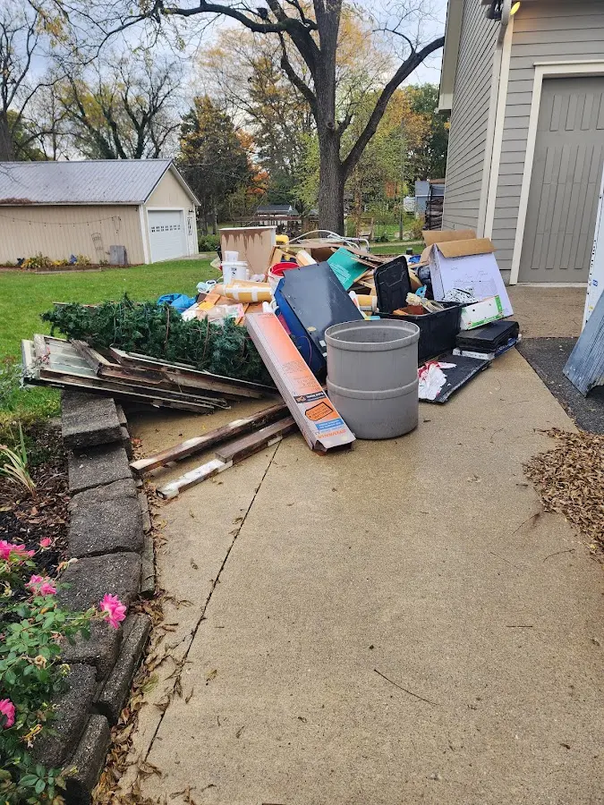 Dumpster being loaded with debris for 12 Yard Dumpster Rental in Somersworth